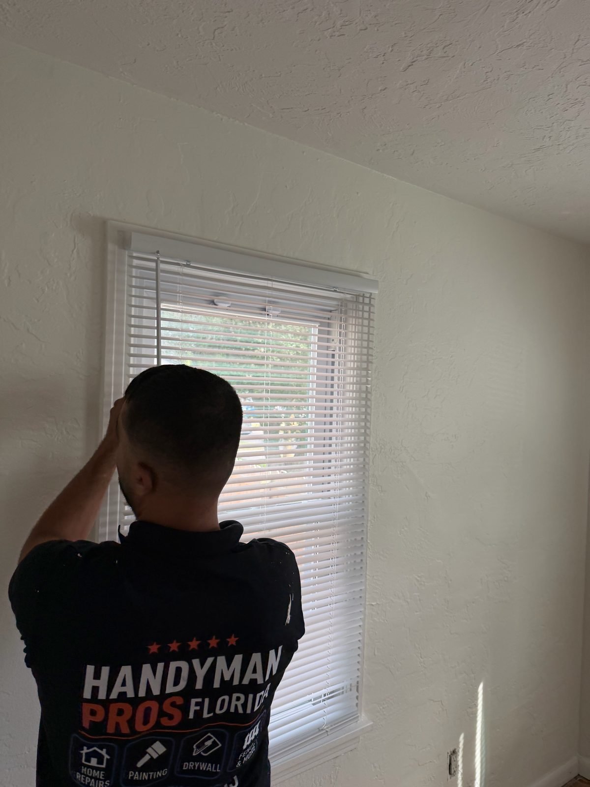 Handyman Pros Florida installing white mini blinds at a residential window