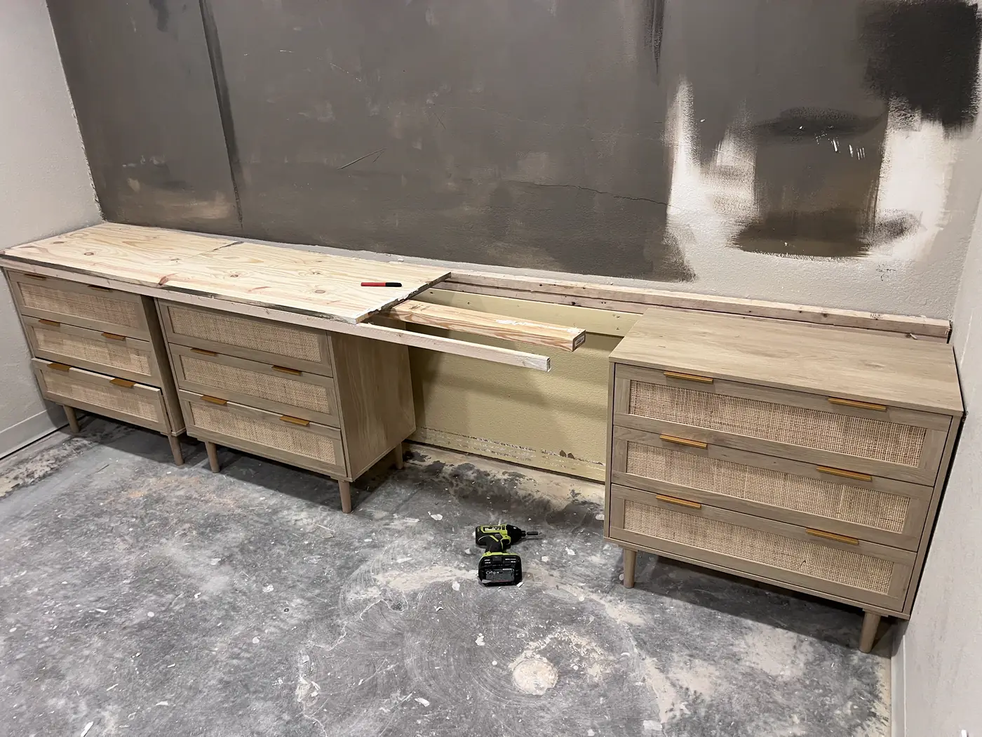 Built-in drawer cabinets and a console under construction against a patched drywall wall, Handyman Pros Florida