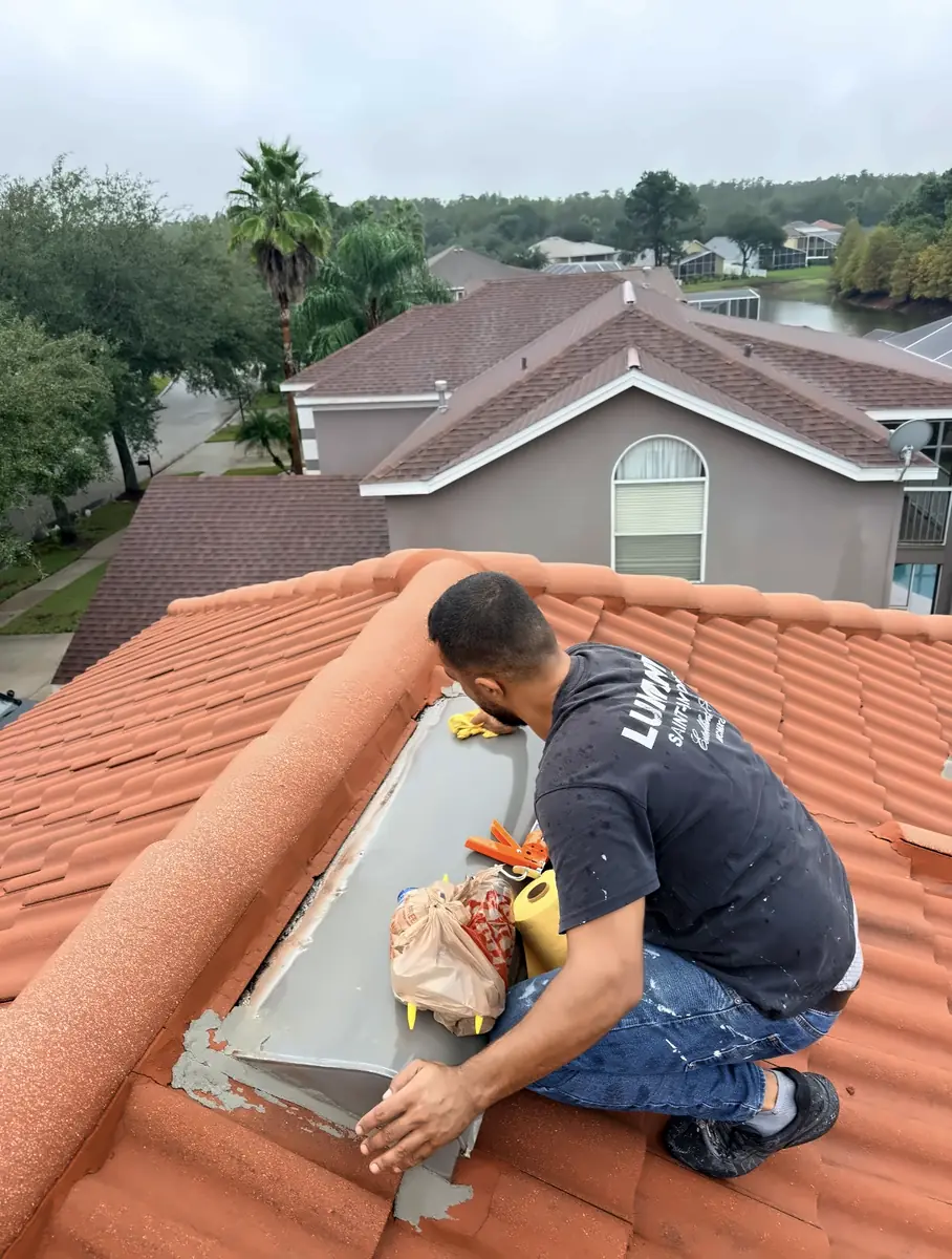 Handyman Pros Florida crew member sealing around a roof vent on a clay barrel tile roof to patch a leak in the Tampa Bay area