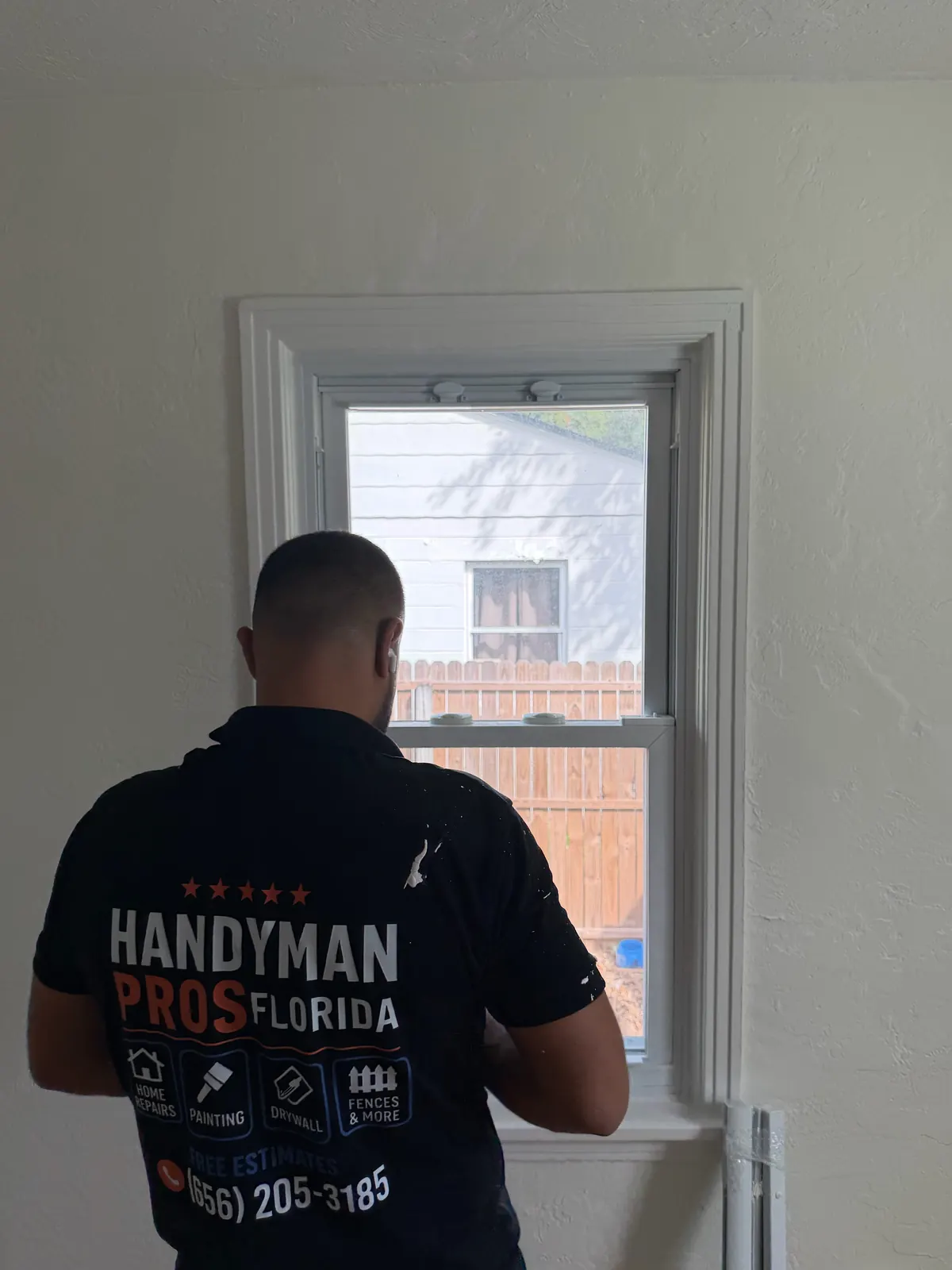 Handyman Pros Florida technician fitting interior trim around a double-hung window in a Tampa Bay home