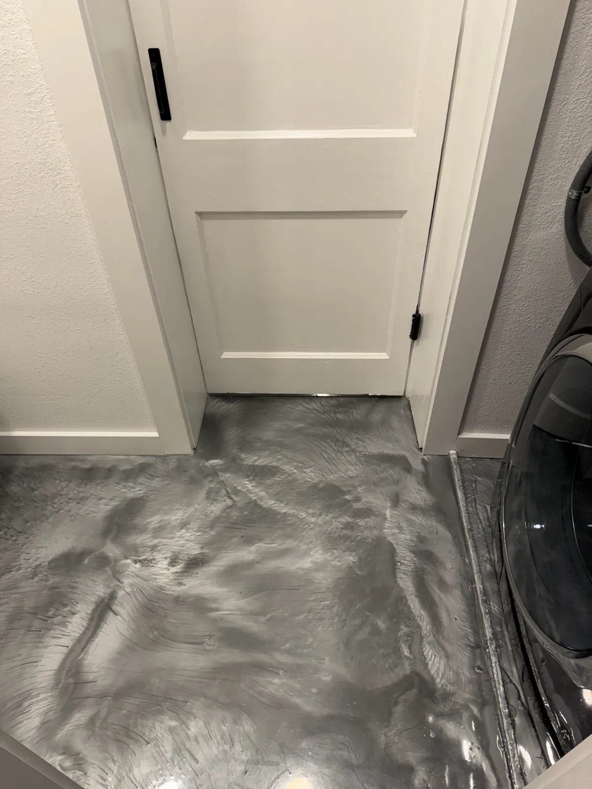 Metallic epoxy floor finished in a laundry room in Tampa Bay